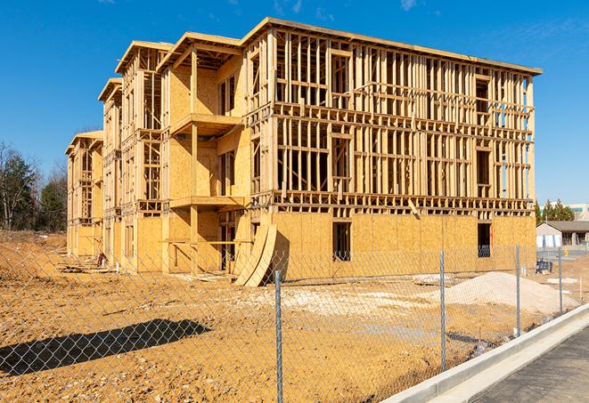 a temporary chain link fence locking away a building under renovation, serving as a security tool in Santa Maria, TX